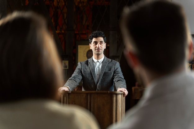 Young pastor preaching at church