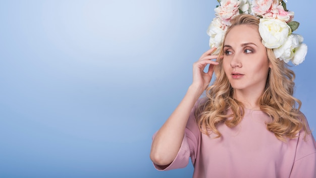 Free photo young pensive blond lady with beautiful flower wreath