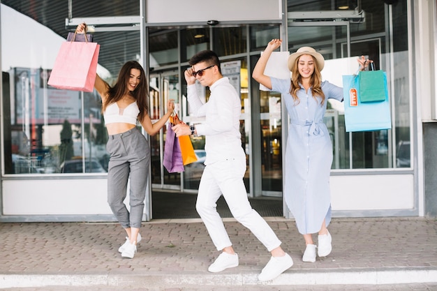 Free photo young people dancing after shopping