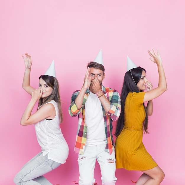 Free photo young people dancing on pink background