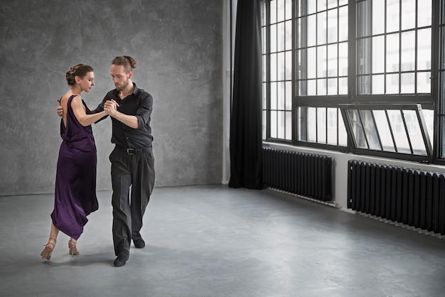 Young people dancing tango in a studio