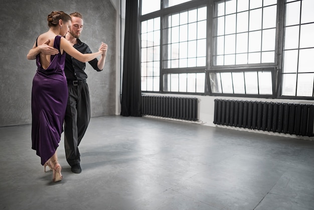 Young people dancing tango in a studio