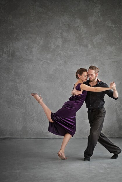 Young people dancing tango in a studio