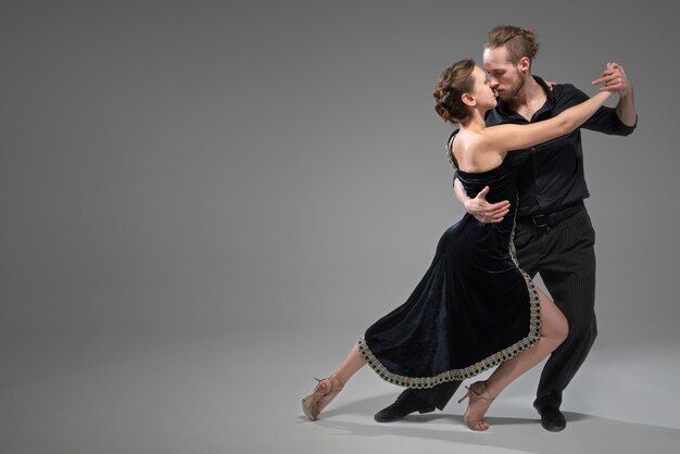 Young people dancing tango in a studio