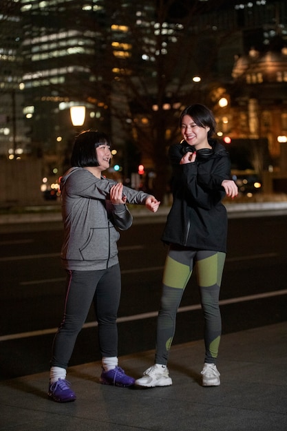 Free photo young people getting ready for doing sport at night