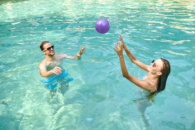 Young people having fun and enjoying at the swimming pool