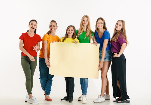 Free photo young people weared in lgbt flag colors isolated on white wall lgbt pride concept