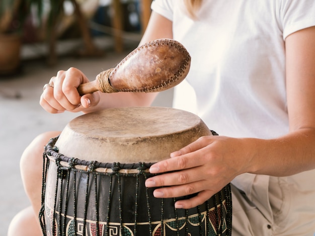 Young person playing african percussion instruments