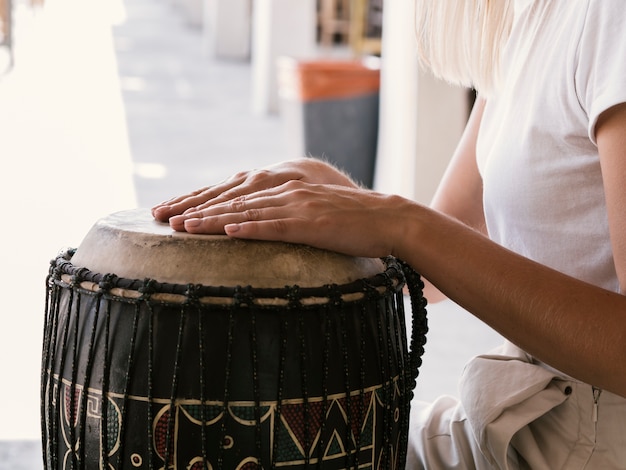 Free Photo young person playing latin percussion instrument