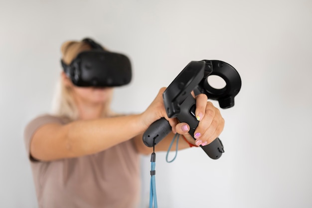 Free photo young person playing videogames with vr glasses