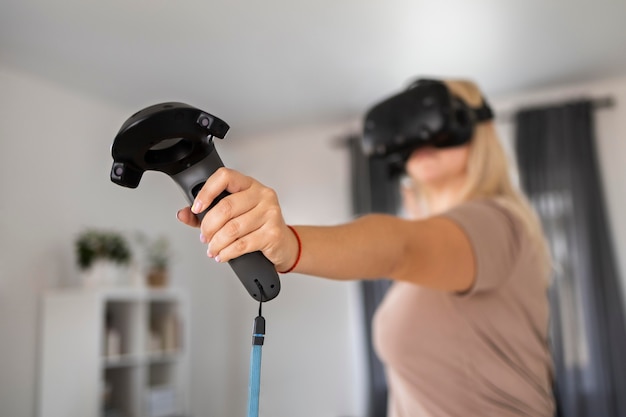 Free photo young person playing videogames with vr glasses