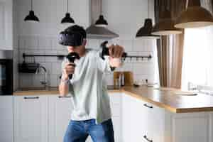 Free photo young person playing videogames with vr glasses