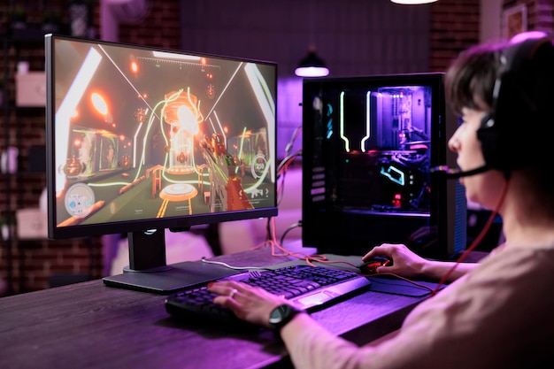 Free photo young person streaming live video games championship on computer monitor, playing online game. female player having fun with action rpg tournament gameplay on pc for entertainment.