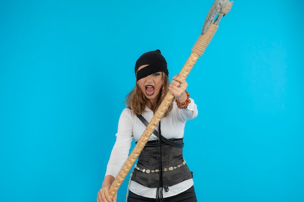 Free photo young pirate raised her ax and attacking. high quality photo