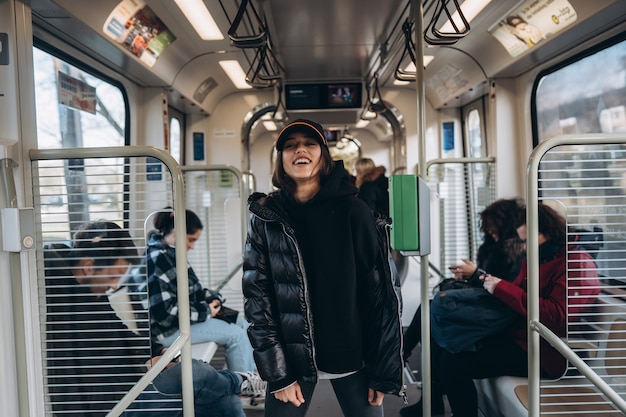 Free photo young posing for the camera in public transport