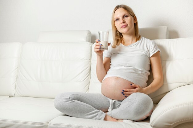 Young pregnant woman drinking milk