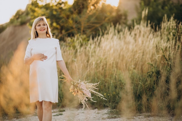 Free Photo young pregnant woman in park