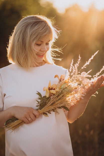 Free Photo young pregnant woman in park