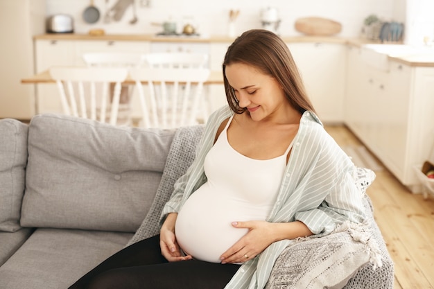 Young pregnant woman posing indoor