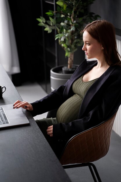 Young pregnant woman at work