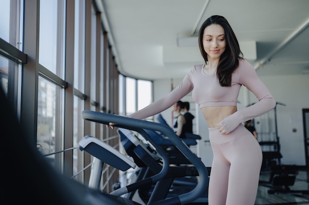 Young pretty girl in sportswear at the gym