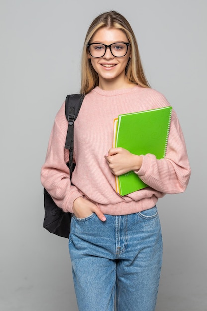 Young pretty student woman posing isolated over white wall