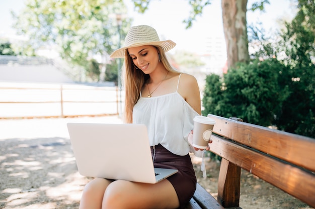 Young pretty woman laptop computer in the park.