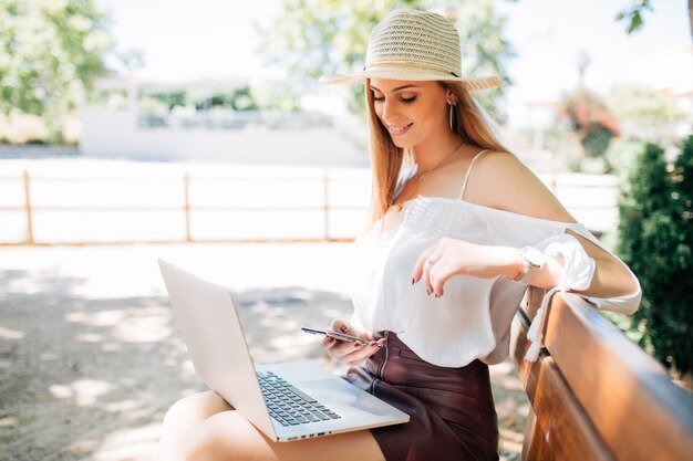 Young pretty woman laptop computer in the park.