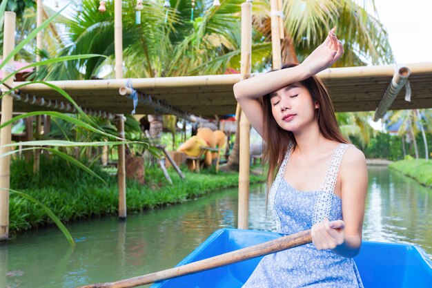 Young pretty woman relaxing by paddling boat