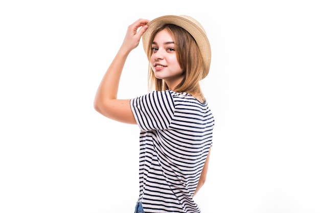 Young pretty woman with straw hat isolated on white wall