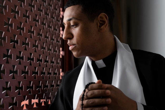 Free photo young priest listening to confession medium shot