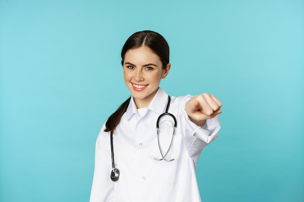 Young professional woman doctor medical worker showing okay ok zero gesture and smiling satisfied re...