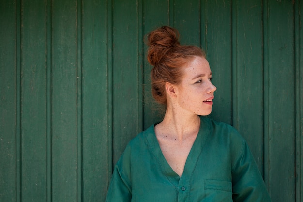 Young redhead woman looking away