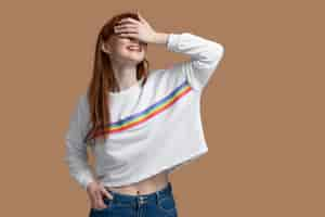 Free photo young redhead woman with rainbow symbol