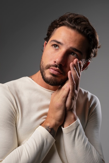 Free photo young and sensitive man praying