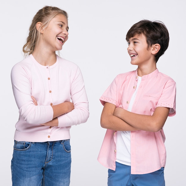 Young siblings standing with arms crossed