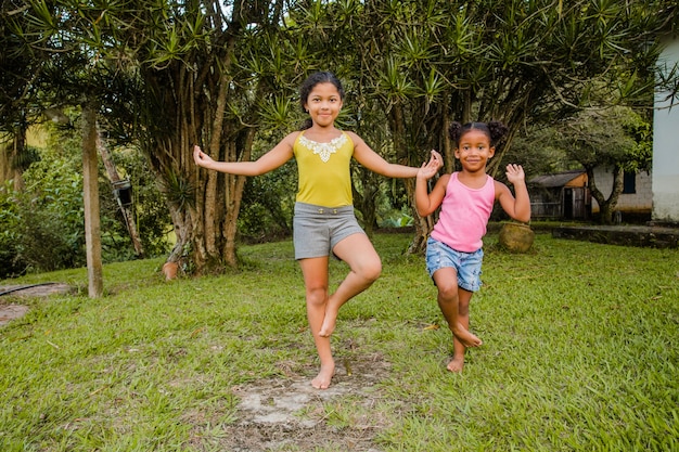 Young sisters playing together in garden