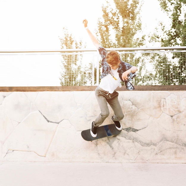 Free photo young skater boy skating in half pipe