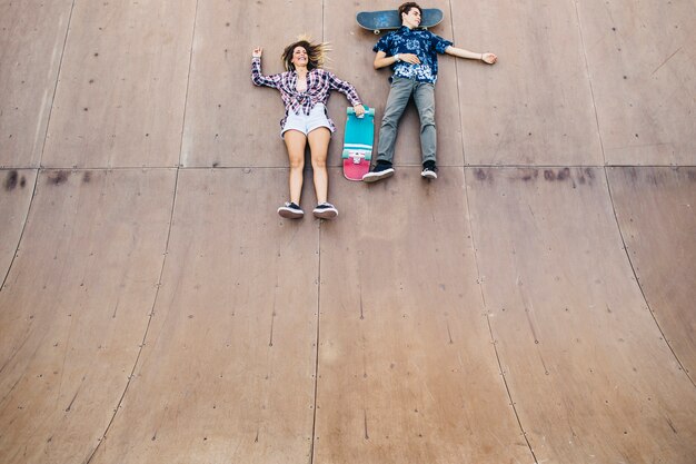 Young skaters laying down on the halfpipe