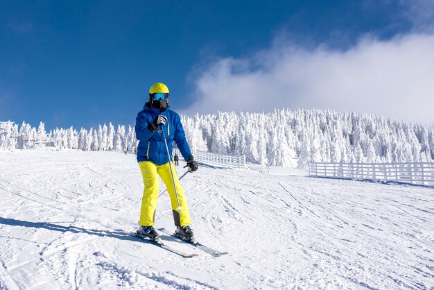 Young skier in motion with a beautiful winter landscape