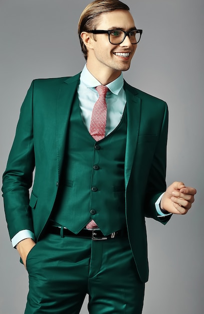 Young smiling elegant handsome  businessman male model in a suit and fashionable glasses,