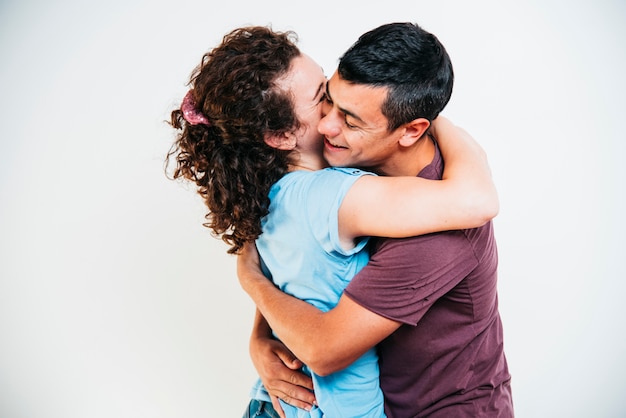 Young smiling man embracing woman