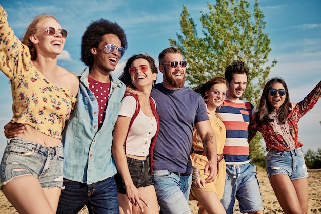 Young smiling people in a row on the fresh air