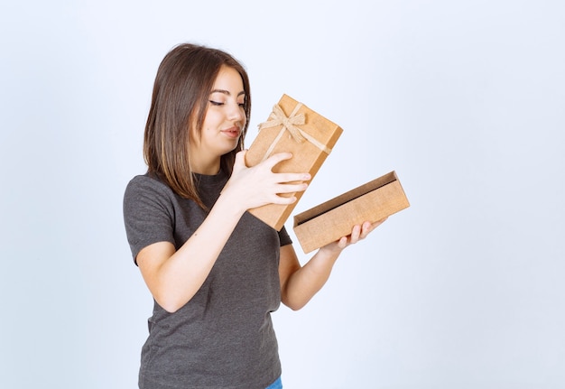 young smiling woman opening a gift box.