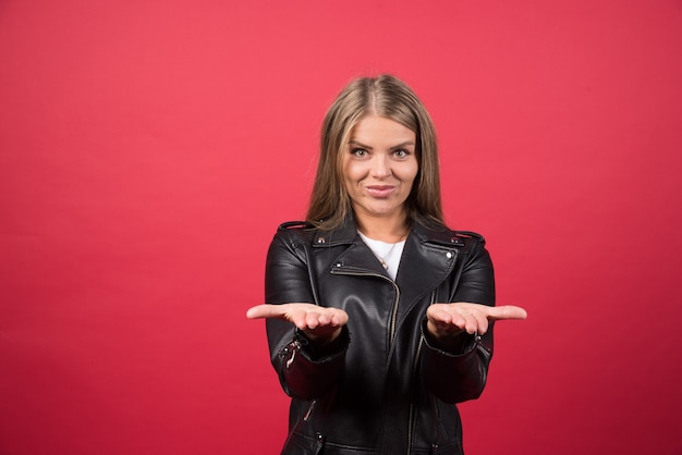 Free Photo young smiling woman standing with hands palms together