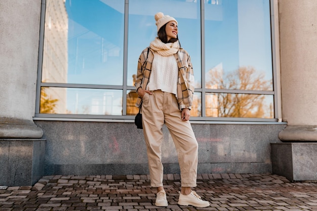 Free Photo young smiling woman walking in street in winter