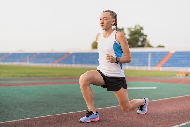 Young sportive woman warm up at stadium