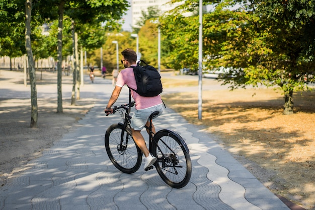 Young sports man on a bicycle in a European city. Sports in urban environments.