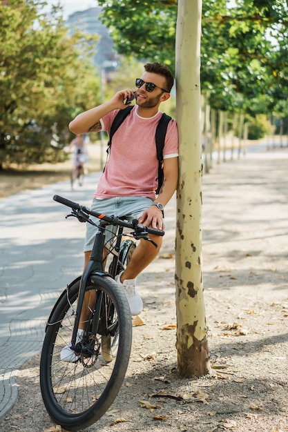 Young sports man on a bicycle in a European city. Sports in urban environments.