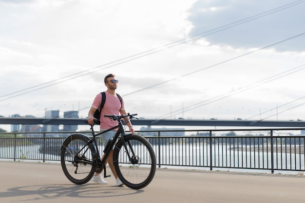 Young sports man on a bicycle in a European city. Sports in urban environments.